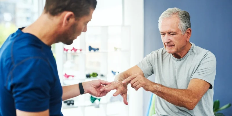 Man with arthritis consulting with physiotherapist